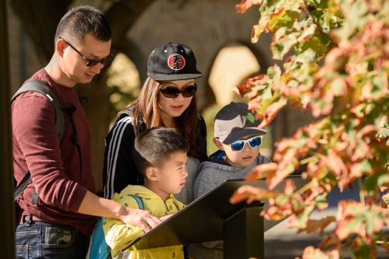 The Xiong family from Shenzhen, China, interacts with one of the new interpretive kiosks.