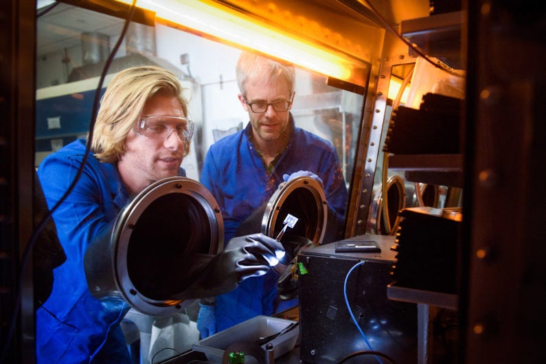 Stanford post-doctoral scholar Tomas Leijtens and Professor Mike McGehee examine perovskite tandem solar cells.