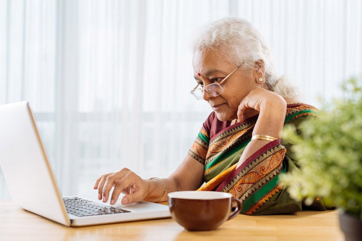 Elderly woman using computer
