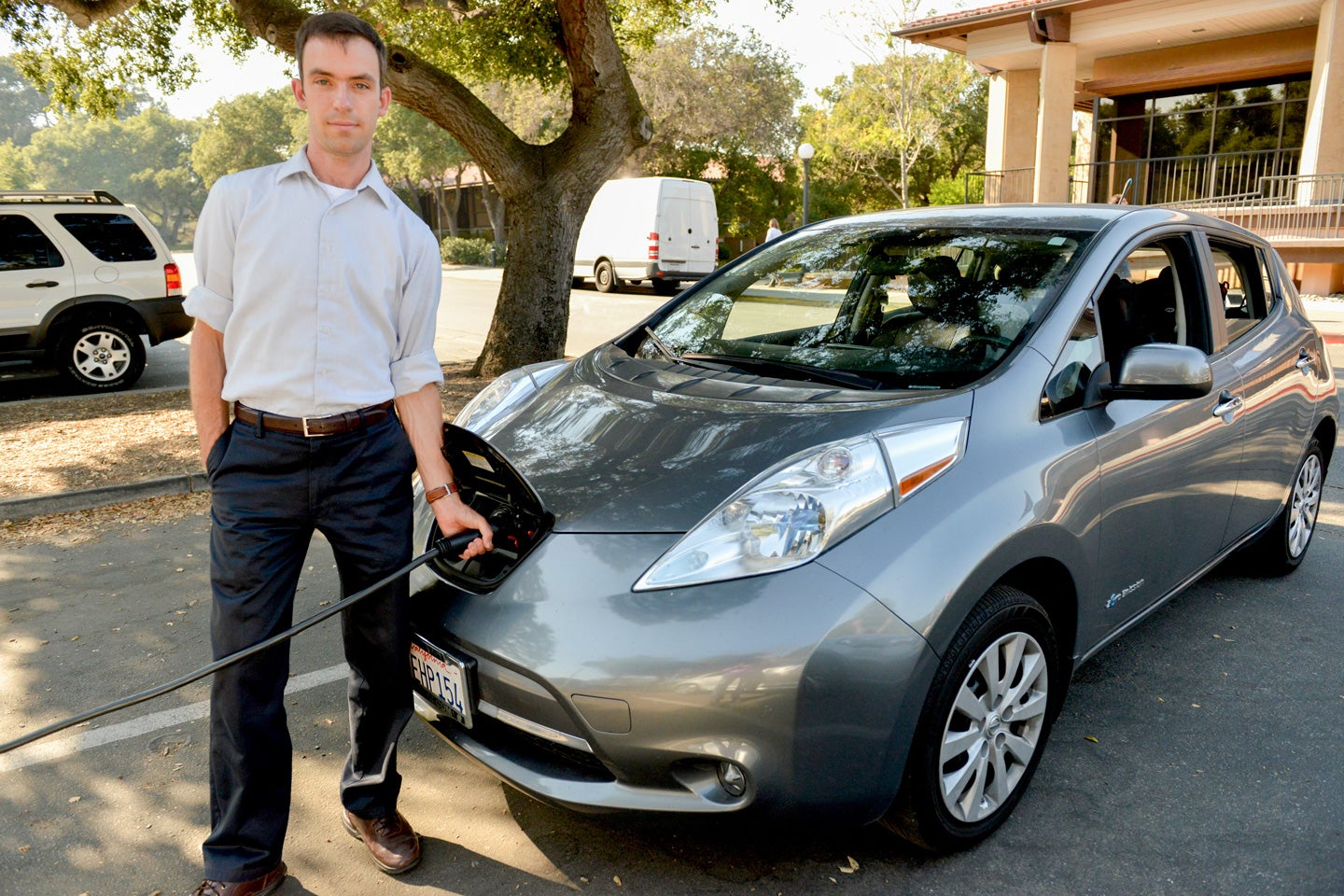 Researcher Matthew Pellow charges his all-electric Nissan Leaf at Stanford. Pellow has found that battery electric vehicles are a more cost-efficient choice for reducing carbon dioxide emissions than cars powered by hydrogen.