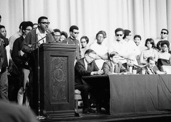 Members of the Black Student Union take the stage and microphone during a program following the assassination of Martin Luther King, Jr., April 8, 1968