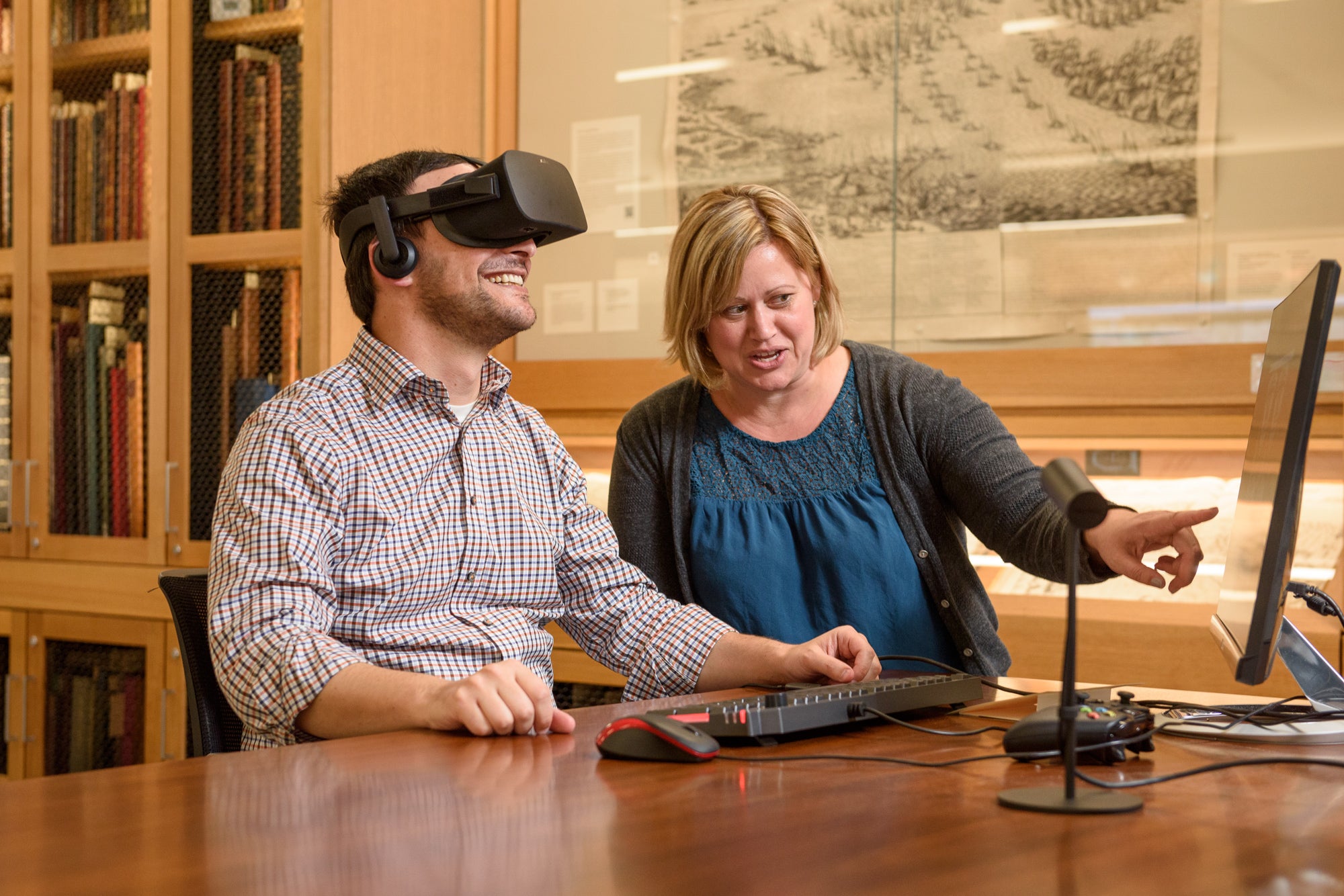 Archivists Josh Schneider and Jenny Johnson viewing virtual reality film