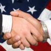 handshake with American flag in background