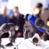 microphones set up on a lectern for a press conference