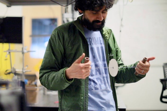 Manu Prakash with a spinning disc whirligig that can be used as a low-cost centrifuge
