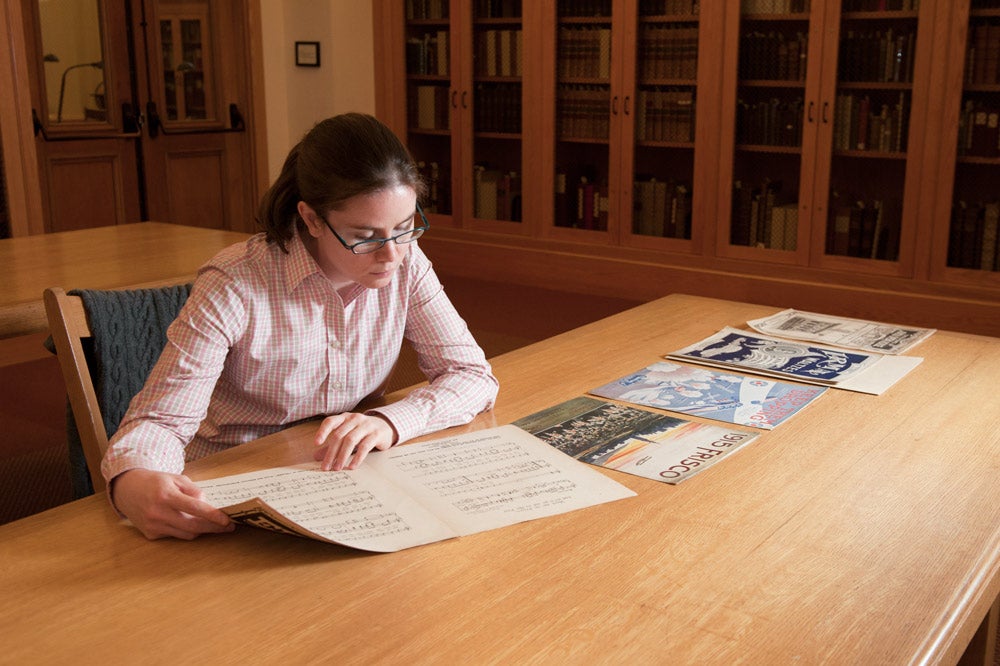 Humanities Center Fellow Amanda Cannata examines some of the World's Fair music that is part of the William R. and Louise Fielder Sheet Music Collection at Green Library.