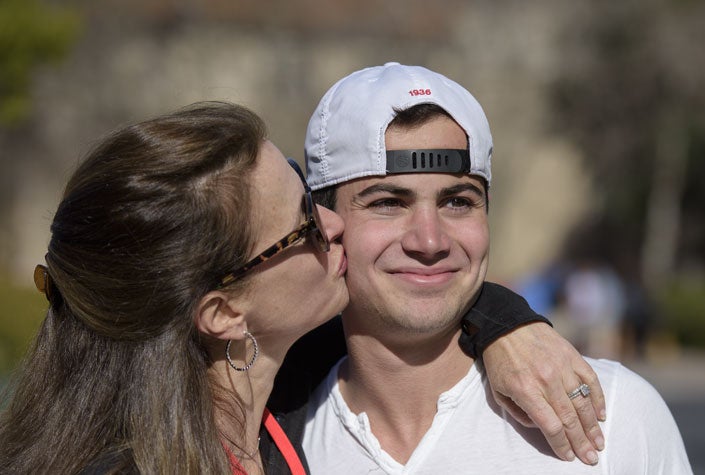 Mom Brenda Feis kisses on cheek her son Andy Feis at 2016 Family Weekend.