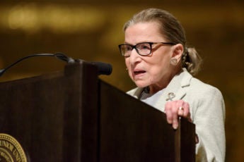 Ruth Bader Ginsburg speaking at a podium