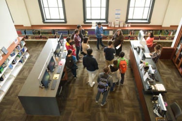Librarian leads students on an orientation of the Li & Ma Science Library