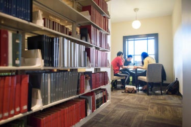 Students around a table in a study area of Li & Ma Science Library