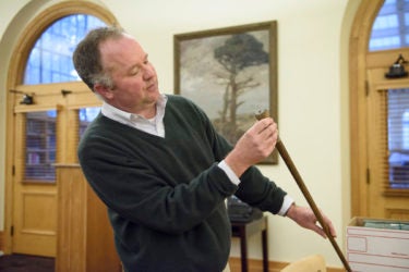 Senior librarian and curator of the sequoia collection Benjamin Stone with a souvenir cane made from a sequoia tree.