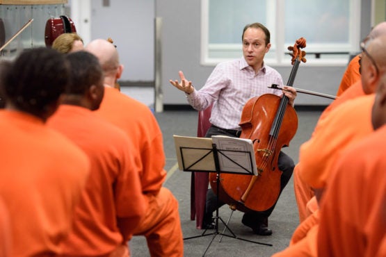Stanford Artist-In-Residence, cellist Christopher Costanza, of the St. Lawrence String Quartet, speaks to a group of inmates at the San Francisco county jail. 