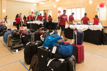 Admits check in at Arrillaga Alumni Center; their luggage is sorted into dorm destination groups.