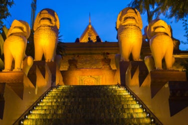 stairway to a temple, with large stone sculptures of lions flanking the stairway