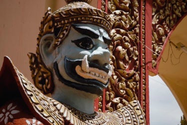 close-up of the face of an ornately carved and painted wooden statue