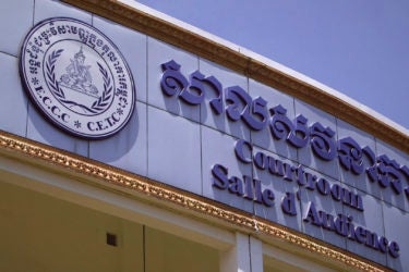sign above the entrance to the courthouse, with "Courtroom" written in Khmer (Cambodian), English and French