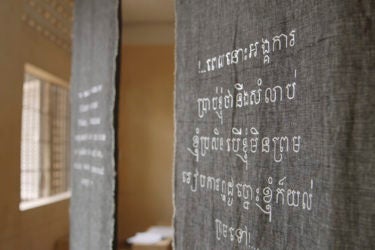 hanging banners with embroidered writing in Khmer (Cambodian) script