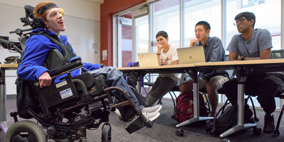 Zach Crighton, a 17-year-old high school student with cerebral palsy, meets with the Compassionate Design class taught by John Moalli. The students are hoping they can make improvements to his wheelchair and communications tools. Zach was brought down from Washington state to answer students questions about his devices.