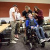 Students in the Compassionate Design class taught by John Moalli take photos of the wheelchair used by Zach Crighton, a 17-year-old high school student with cerebral palsy. The students are hoping they can make improvements to his wheelchair and communications tools.