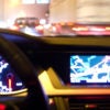 car dashboard and navigation system illuminated at night