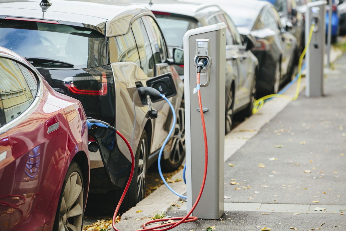 Electric vehicles plug in to charging stations. New research may accelerate discovery of materials used in electrical storage devices, such as car batteries. 