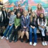 students in front of a mural in San Francisco's Mission District