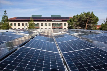 solar panels atop the Hansen Experimental Physics Lab with view toward the photovoltaics on the Huang Engineering Building.