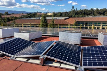 Photovoltaic panels on the roof of Maples Pavilion ready for installation