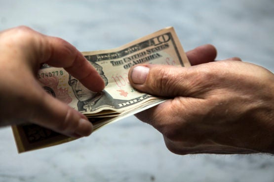 Hands exchanging money 