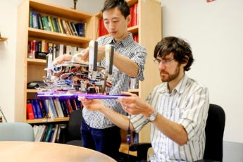 Hao Jiang, graduate student in the Cutkosky lab and lead author of the paper and Elliot Hawkes, MS ‘11, PhD ‘15, a visiting assistant professor from the University of California, Santa Barbara and co-author of the paper, hold the custom robotic gripper.