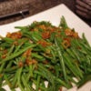 green beans with shallots in a serving dish