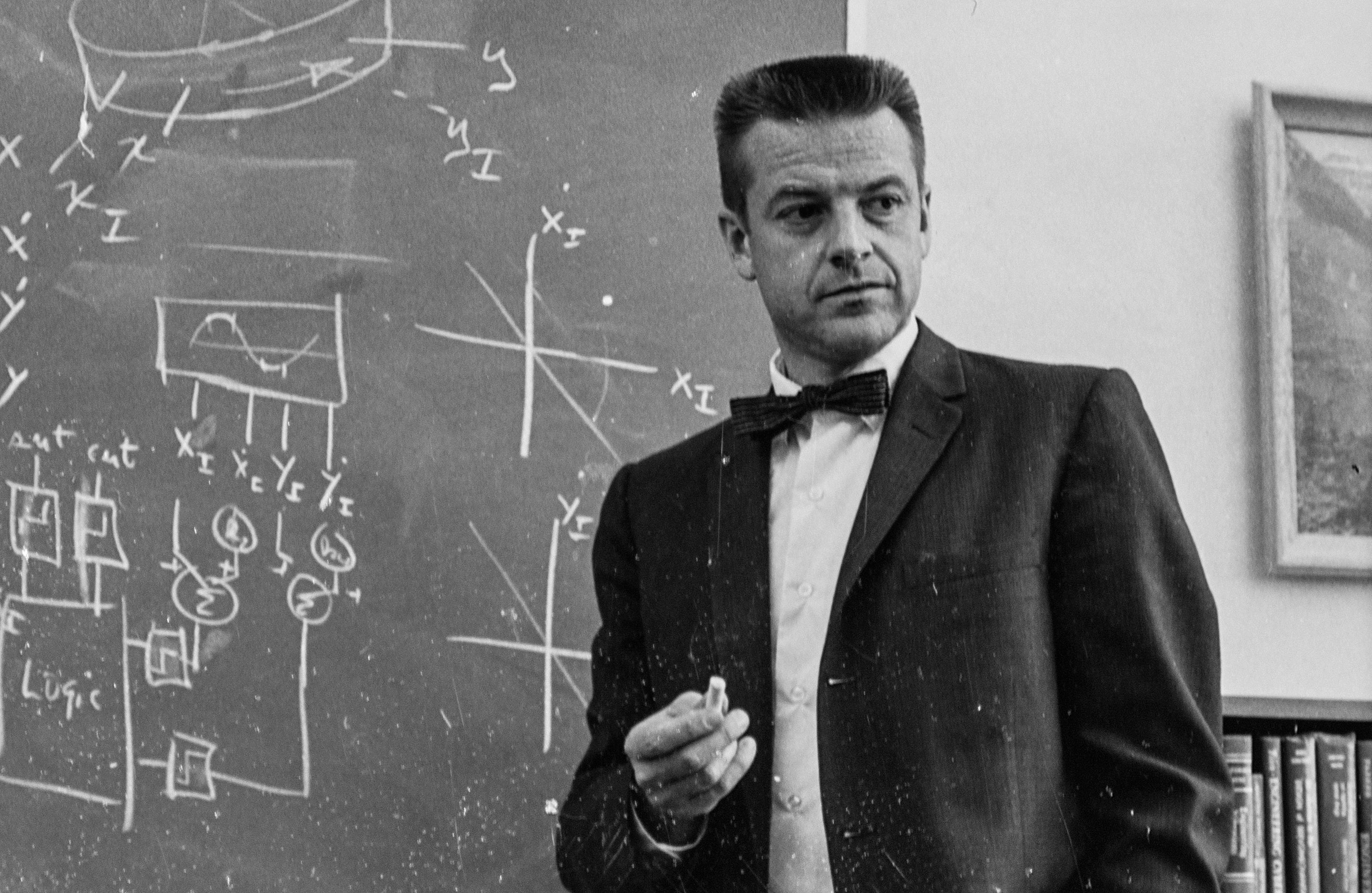 Historic photo of Robert Cannon at chalkboard with mathematical formulas