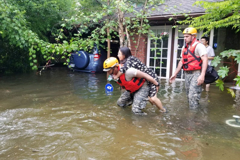 Texas National Guard troops rescue stranded families from Houston flooding.