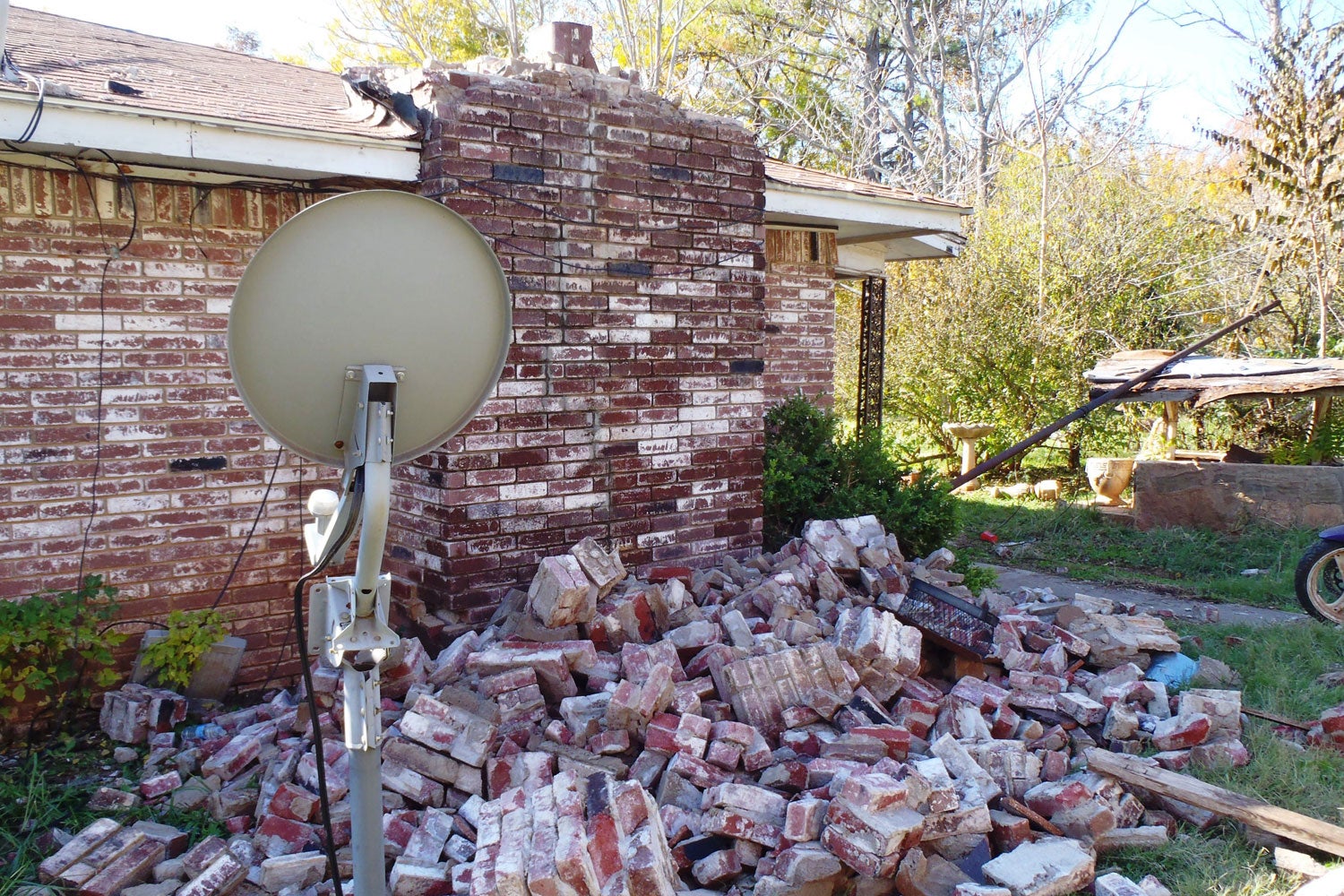 A fallen brick chimney of a house in Oklahoma after a magnitude 5.6 earthquake likely induced by injection into deep disposal wells in the Wilzetta North field; Nov. 6, 2011.