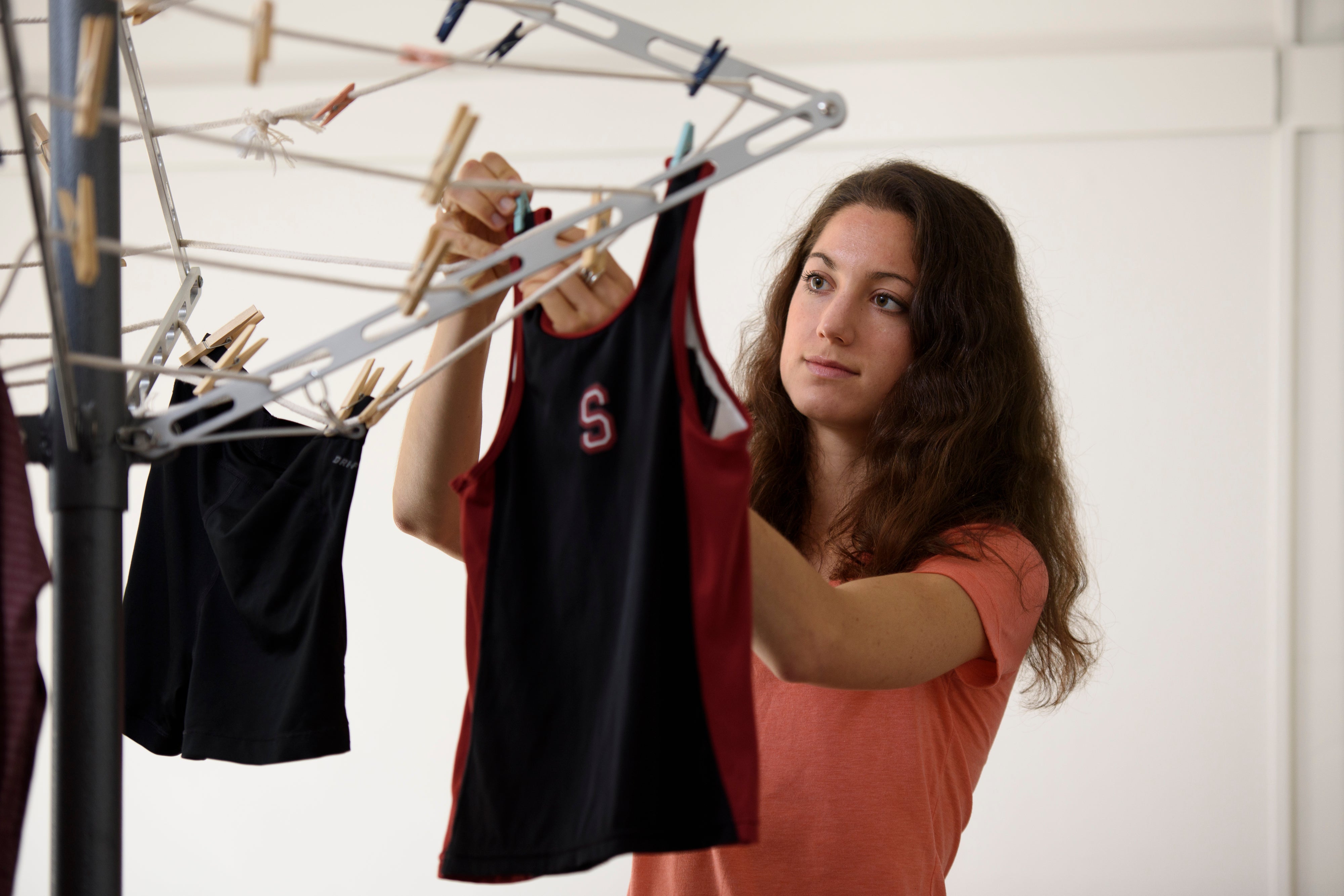 Danielle Katz hangs her cross country uniform on the drying rack she designed in her mechanical engineering class.