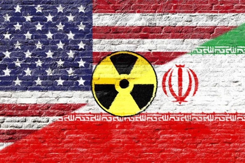 Iranian and U.S. flags with nuclear logo