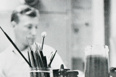 A Stanford University Press designer works at his desk in 1959.