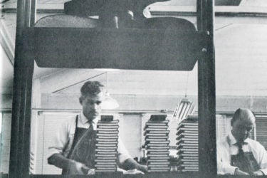 A 1959 photo shows Stanford University Press' workers next to a pressurizer.