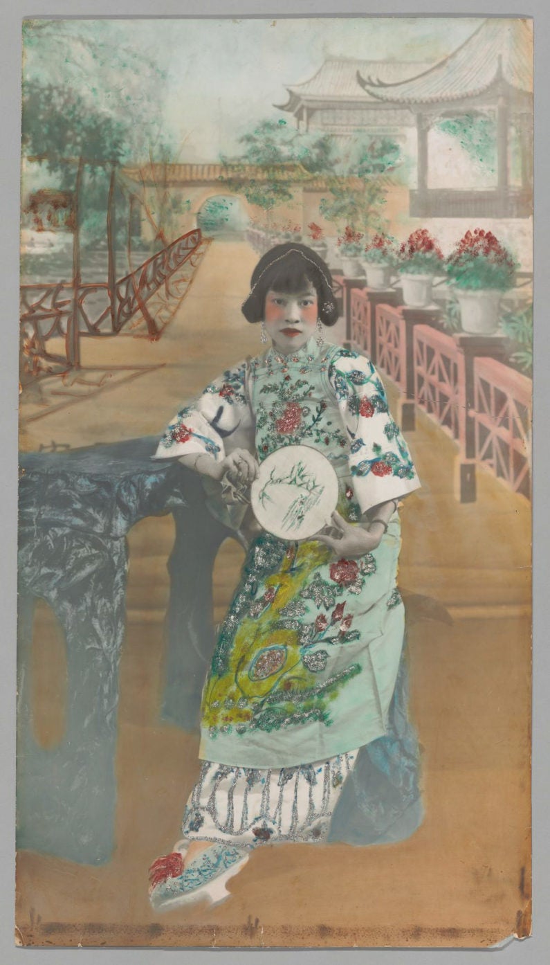 This hand-colored portrait shows an actress in traditional Chinese theater costume.