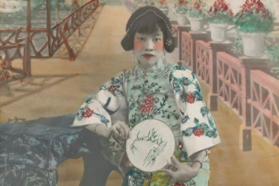 This hand-colored portrait shows an actress in traditional Chinese theater costume.