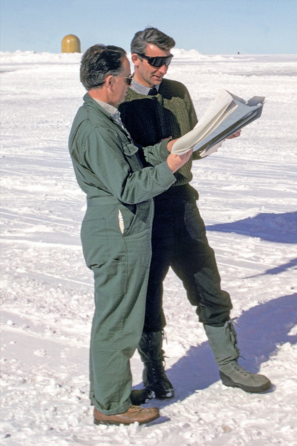 Gordon Robin (left) and Stan Evans discussing flights at Williams Field in Antarctica’s McMurdo Sound in January 1970. 