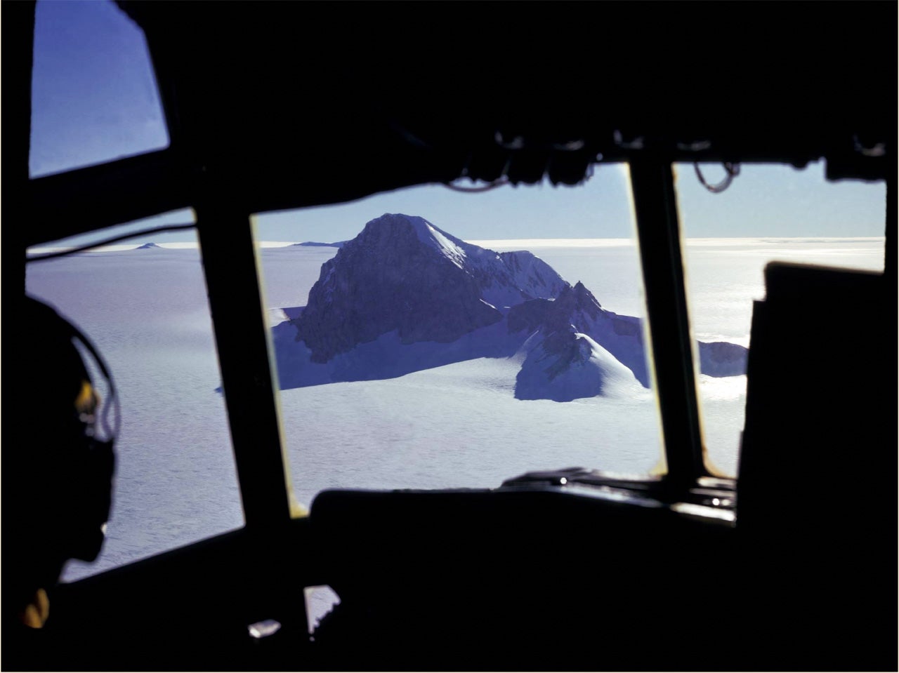View of Whitmore Mountain in central West Antarctica from the C-130 flight deck. Mountain peaks provided valuable fixed points for navigation as well as regions for scientific investigation. 