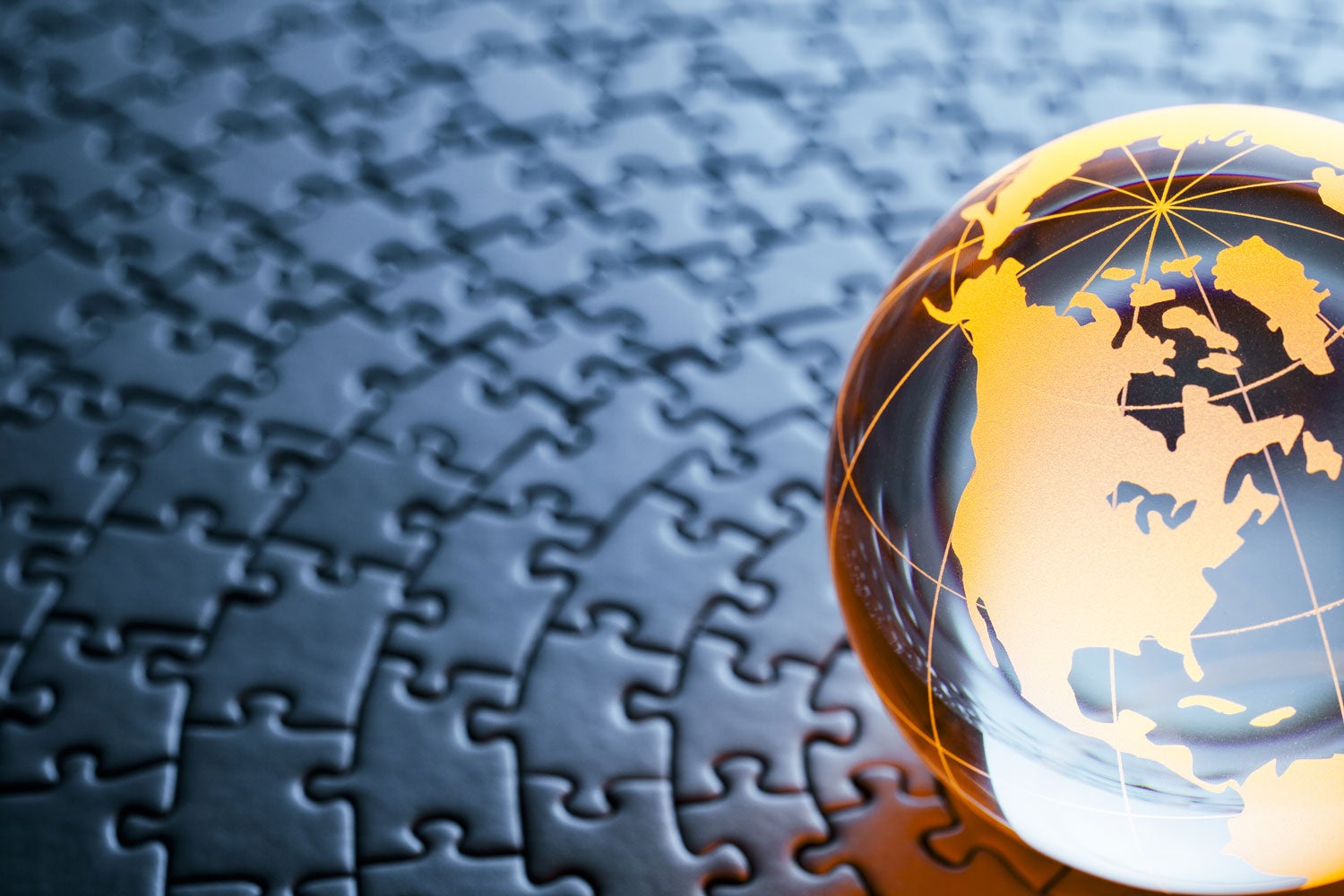 a crystal globe featuring North America sitting on a jigsaw puzzle background