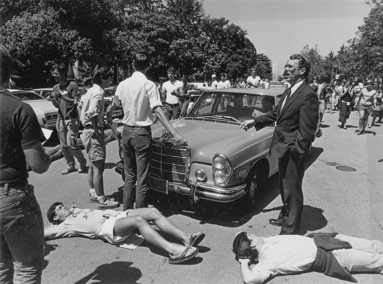 April 1985: Students protesting university investments in South Africa block trustees' cars. At right is police chief Marvin Herrington.