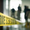 crime scene tape with blurred forensic law enforcement background in cinematic tone and copy space