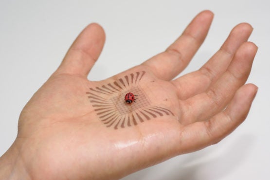 A pixelated electronic sensor built with skin-like materials conforms to a palm