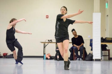 Graduate students Colette Kelly and Glory Liu perform a movement combination.