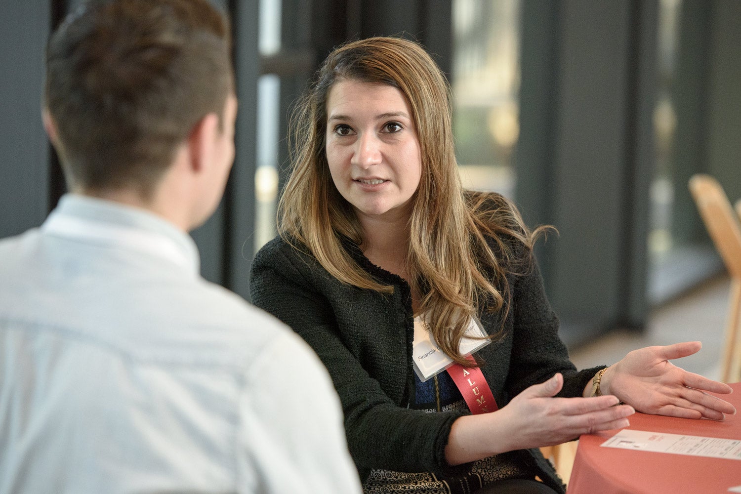 Erika Topete meets with a prospective graduate student at a recent event on financial literacy..