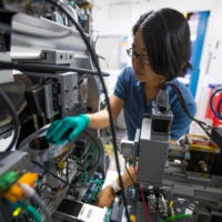 Fang Ren, who developed algorithms to analyze data on the fly while a postdoctoral scholar at SLAC, at a Stanford Synchrotron Radiation Lightsource beamline where the system has been put to use.