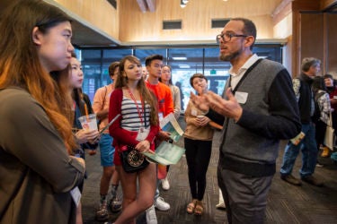 Professor Vaughn Rasberry talks with admitted students.